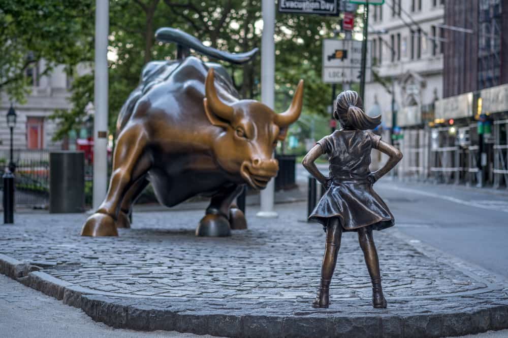 In this photo the Wall Street bull and a girl.